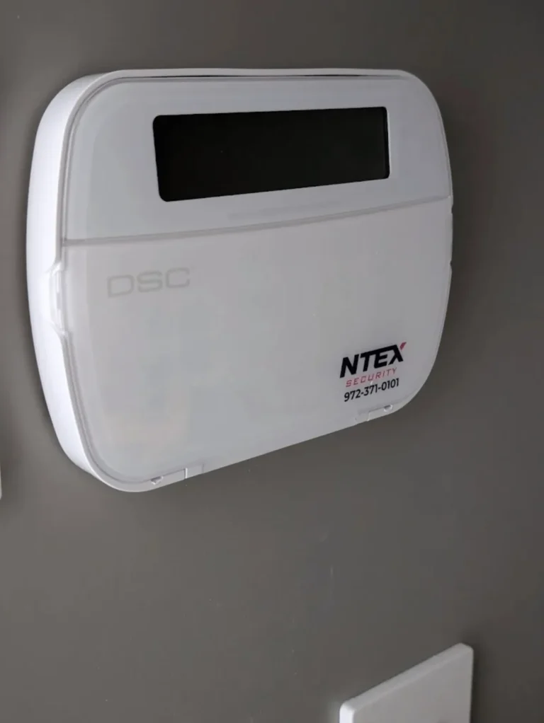 Wall-mounted alarm keypad with NTEX Security label