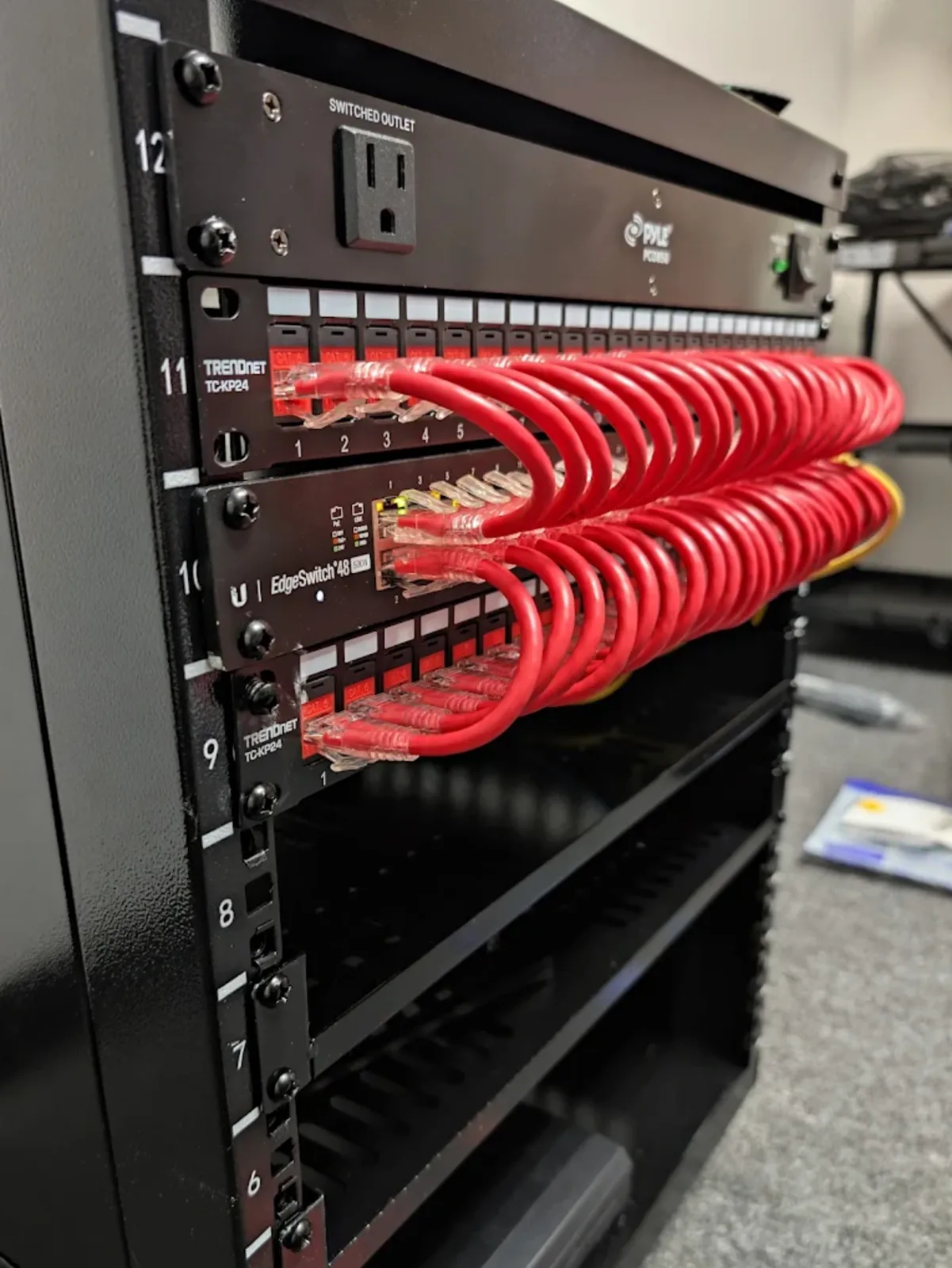 Organized red network patch cables in an equipment rack